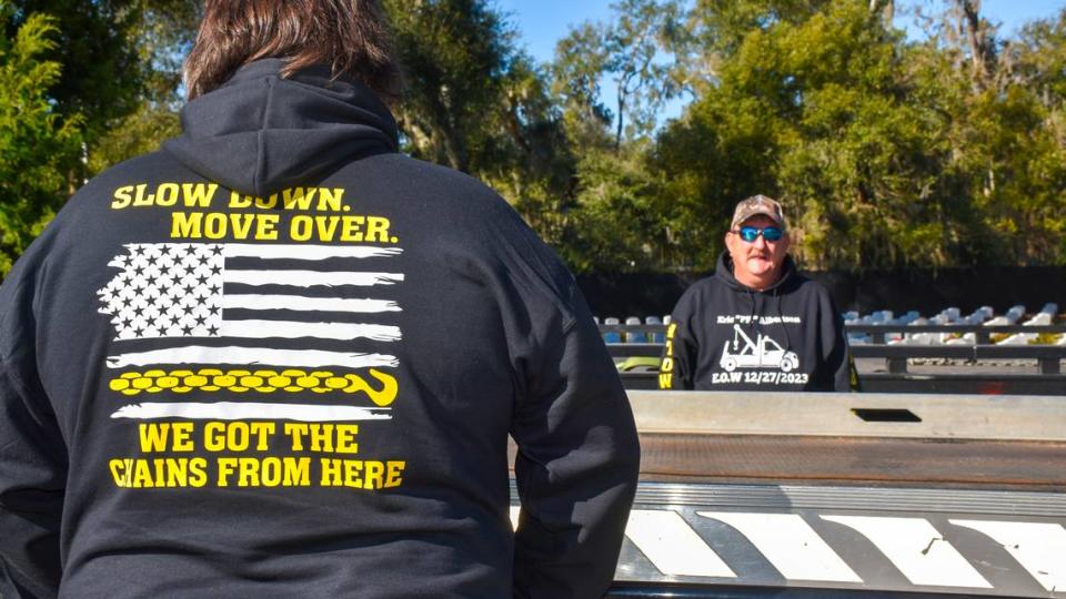 Employees with A1 Towing wear hoodies commemorating the life of former employee and 12-year Marine Veteran Eric Albertson on Wednesday, Jan. 10, 2024, at Beaufort National Cemetery.
