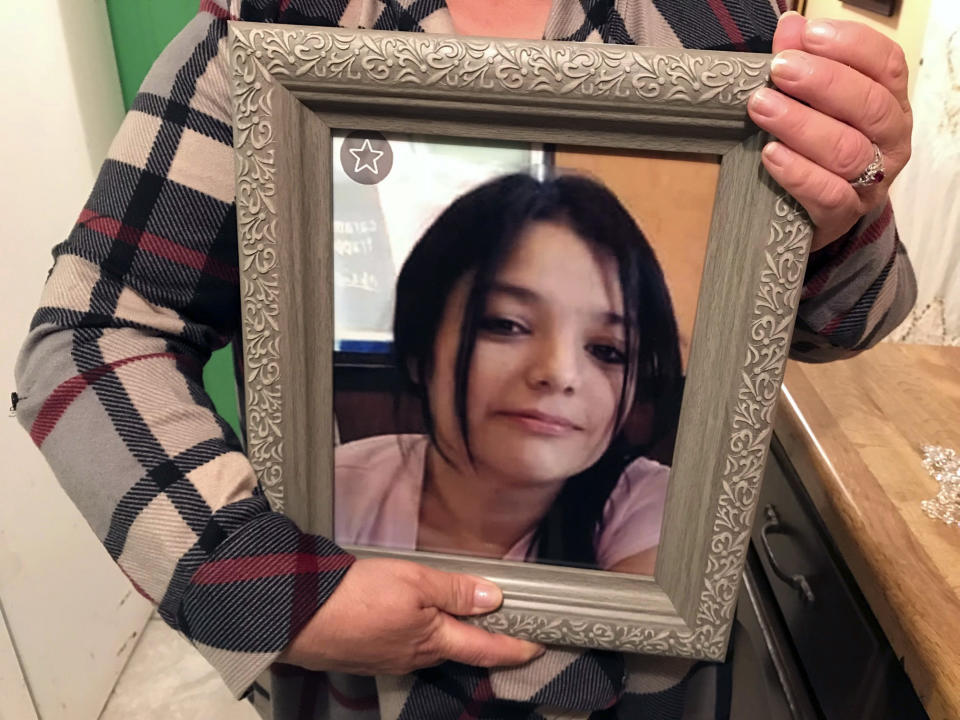 Maria Cristina Benevidez holds a photograph of her daughter, Melissa Ramirez, at her home in Rio Bravo, Texas. Ramirez is one of four women authorities say were killed by a Border Patrol supervisor. (AP Photo/Susan Montoya Bryan)
