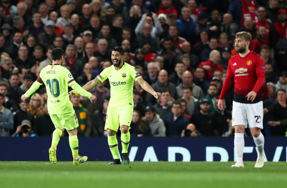 Luis Suarez celebrates after Luke Shaw diverted his header into the bottom corner as Barcelona beat Manchester United