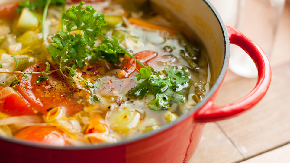 Soup cooking in a red Dutch oven