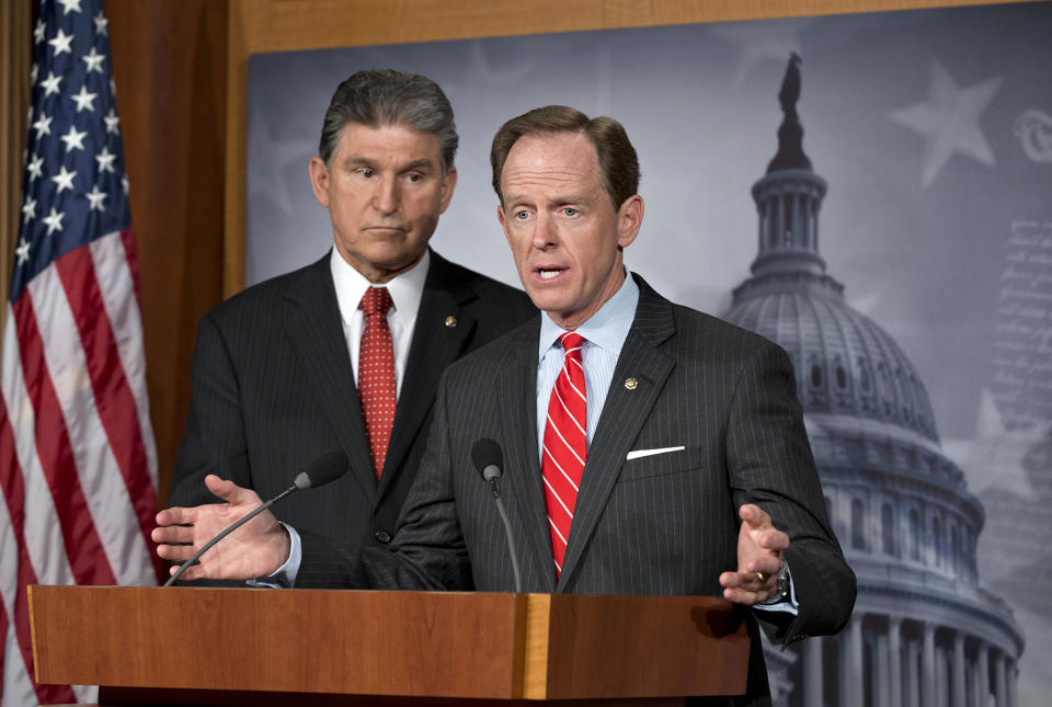 Democratic Sen. Joe Manchin of West Virginia, left, and Republican Sen. Patrick Toomey of Pennsylvania, right, announce that they have reached a bipartisan deal on expanding background checks to more gun buyers, at the Capitol in Washington in April 2013. A bipartisan gun control deal by Toomey and Manchin inspired Senate conservatives to drop their filibuster plans, even though many Republicans who allowed the legislation to advance said they were unlikely to vote for its passage in the end. (AP Photo/J. Scott Applewhite, File)