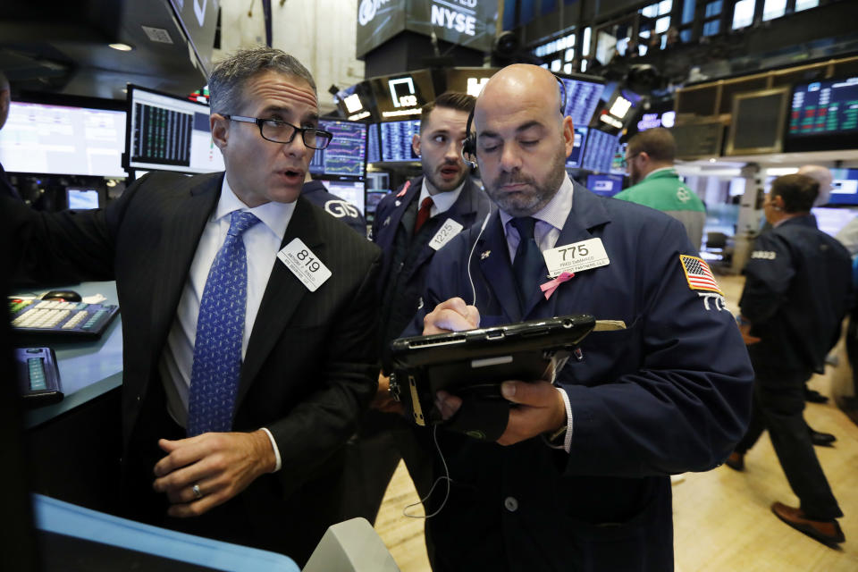 Specialists Anthony Rinaldi, left, and Matthew Greiner, center, work with trader Fred DeMarco on the floor of the New York Stock Exchange, Wednesday, Nov. 7, 2018. Stocks are climbing in early trading on Wall Street as results of the U.S. midterm elections came in as investors had expected. (AP Photo/Richard Drew)