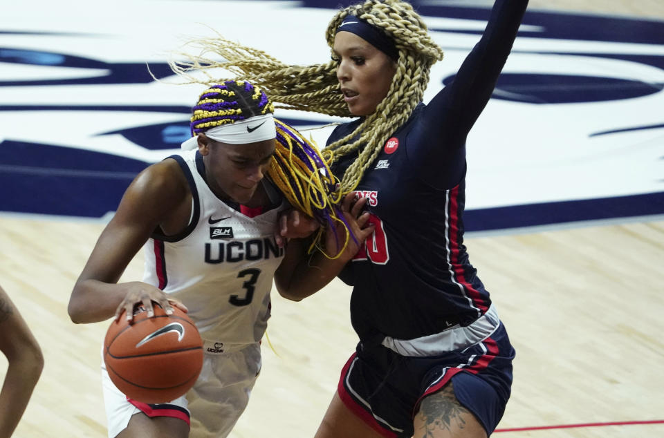 Connecticut forward Aaliyah Edwards (3) drives the ball against St. John's forward Rayven Peeples (20) during the second half of an NCAA college basketball game Wednesday, Feb. 3, 2021, in Storrs, Conn. (David Butler II/Pool Photo via AP)