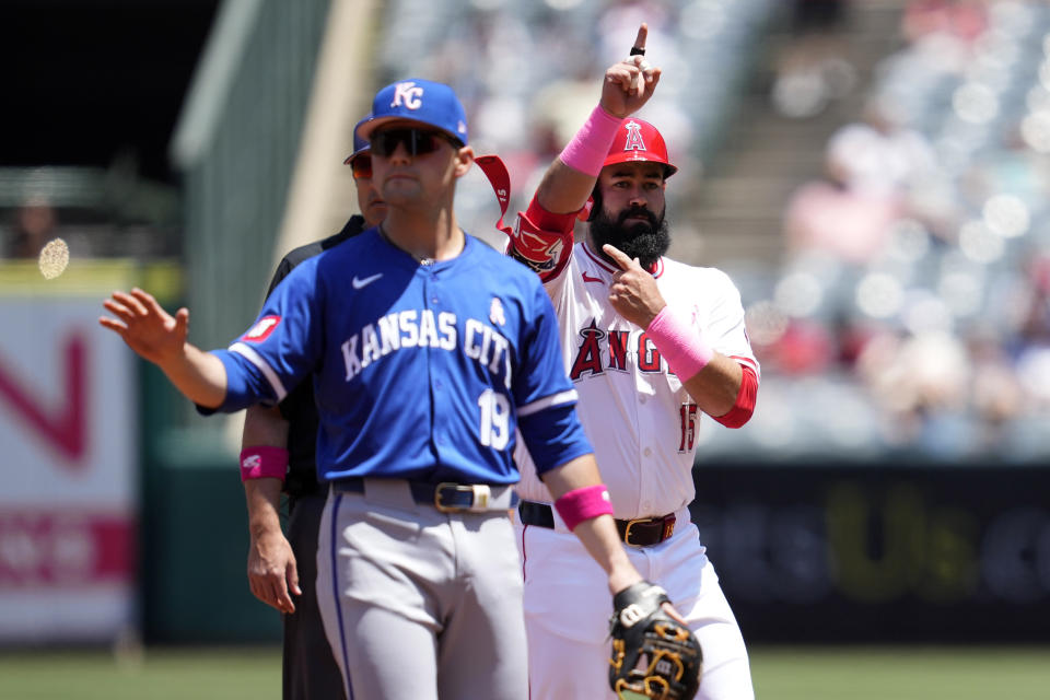 Los Angeles Angels' Luis Guillorme, right, gestures toward his dugout after hitting a double as Kansas City Royals second baseman Michael Massey stands by during the first inning of a baseball game Sunday, May 12, 2024, in Anaheim, Calif. (AP Photo/Ashley Landis)