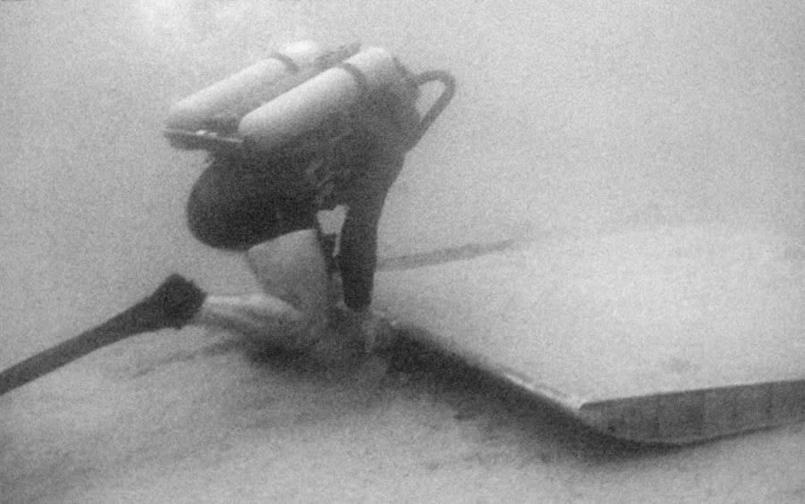 A U.S. scuba diver surveys a piece of aircraft wreckage that was found at depth 130 feet in waters of Palomares during search for missing H-Bomb in Palomares Beach, Spain on March 9, 1966. (AP Photo)