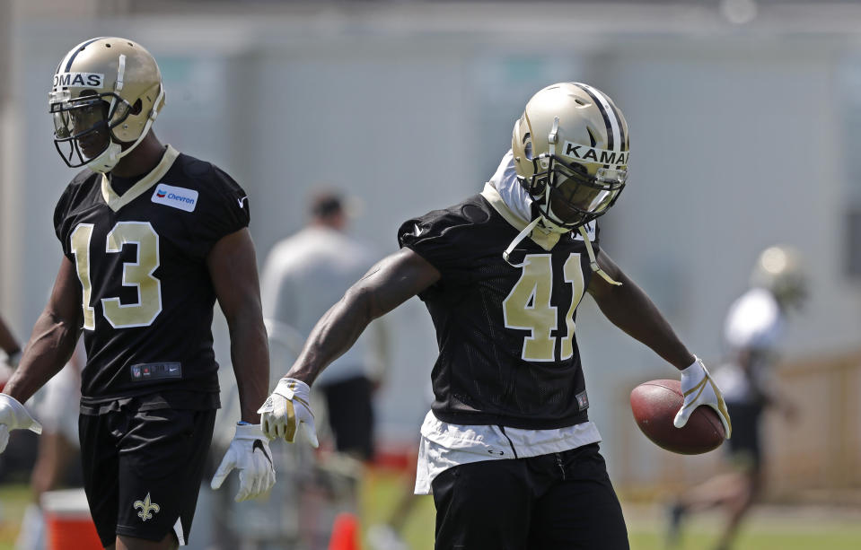 New Orleans Saints running back Alvin Kamara (41) and receiver Michael Thomas (13) are on opposite sides of overrated and underrated fantasy draft picks. (AP Photo/Gerald Herbert)