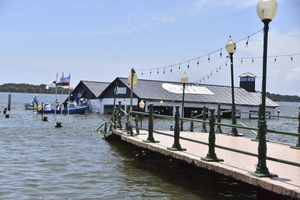 The Marine Museum of Puerto Bolivar, detached from the dock, is partially inundated in water after an earthquake that shook Machala, Ecuador, Saturday, March 18, 2023. The U.S. Geological Survey reported an earthquake with a magnitude of about 6.8 that was centered just off the Pacific Coast, about 50 miles (80 kilometers) south of Guayaquil. (AP Photo/Jorge Sanchez)