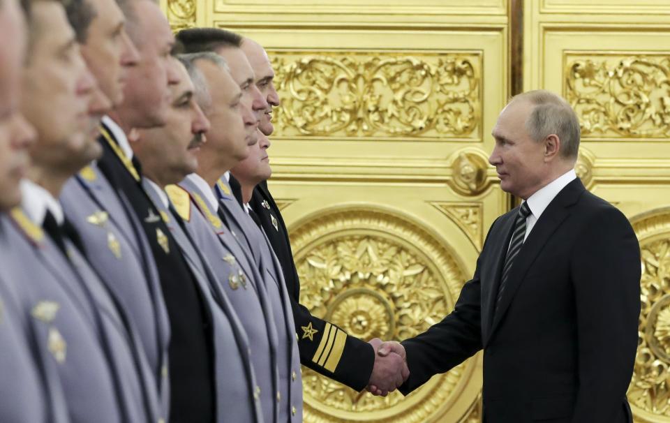 Russian President Vladimir Putin greets senior military officers during a meeting in Moscow, Russia, Wednesday, Nov. 6, 2019. Putin said Russia's new weapons have no foreign equivalents but he insists the country will not use them to threaten anyone. (Mikhail Klimentyev, Sputnik, Kremlin Pool Photo via AP)