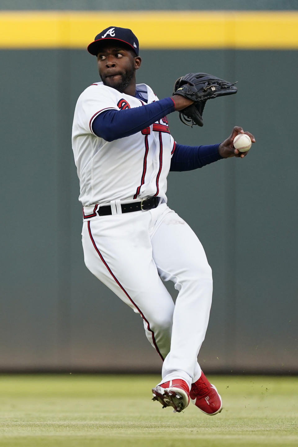 Atlanta Braves center fielder Guillermo Heredia throws after fielding a ball hit for a single by Washington Nationals' Josh Harrison in the first inning of a baseball game Tuesday, June 1, 2021, in Atlanta. (AP Photo/John Bazemore)