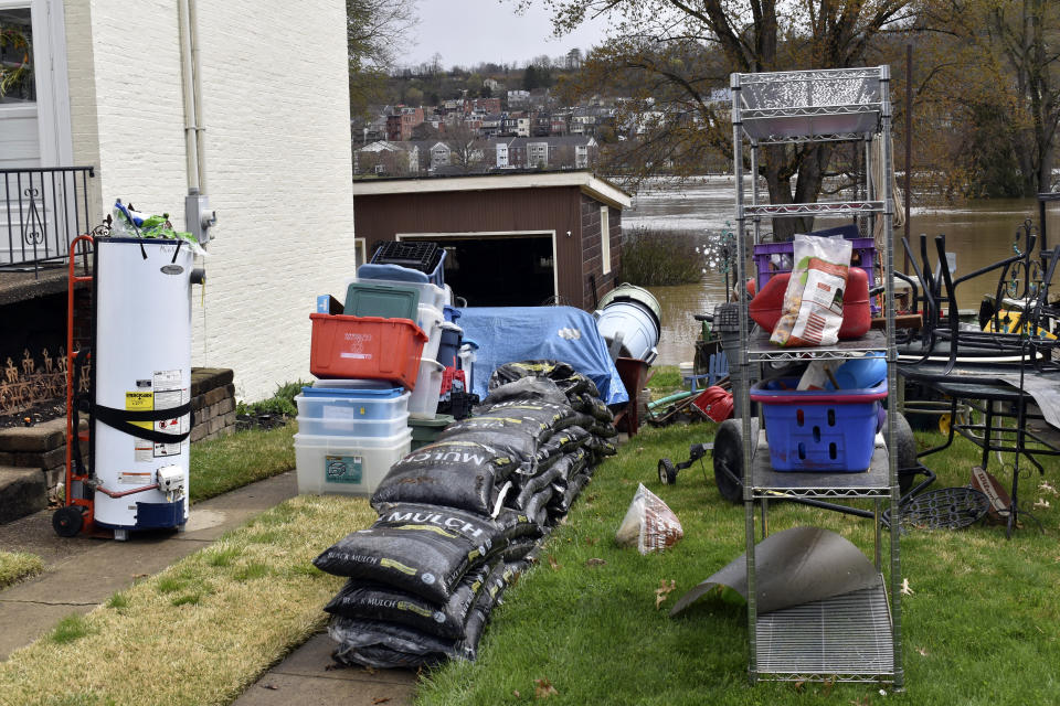 A water heater and other items were removed from the lower level of a home on Wheeling Island as the Ohio River floods its banks, Thursday, April 4, 2024, in Wheeling, W.Va., following days of heavy rains in the region. (Eric Ayres/The Intelligencer via AP)