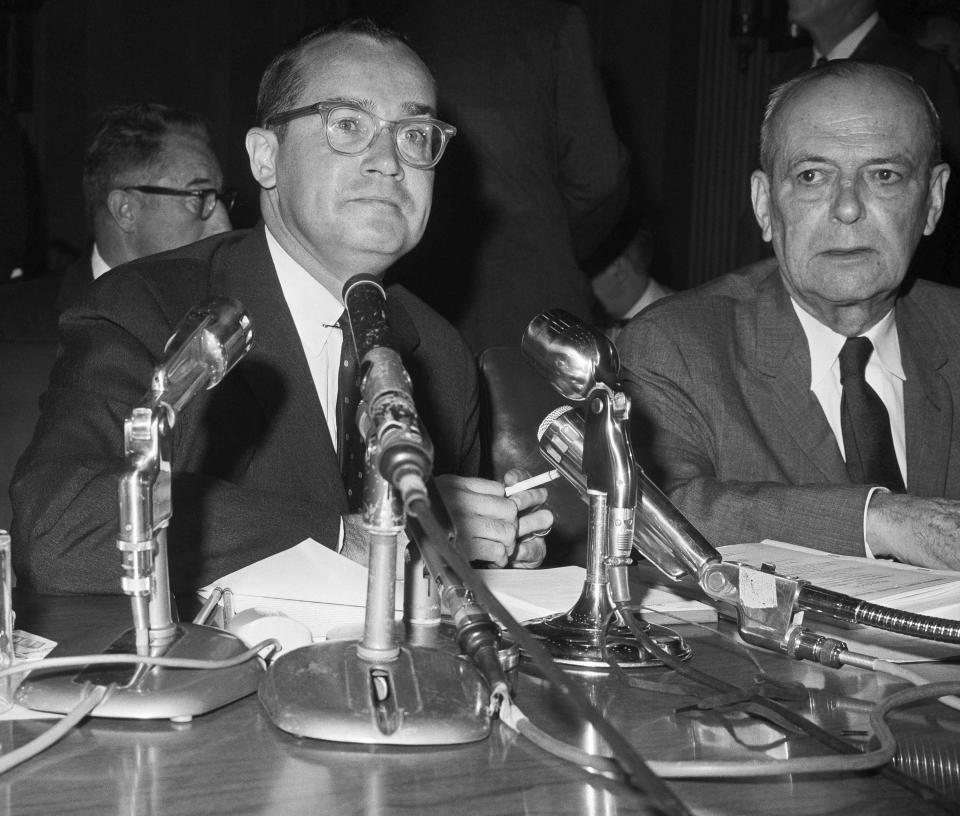 FILE - Chairman Newton Minow, left, of the Federal Communications Commission testifies before the Senate Foreign Relations Committee, Aug. 3, 1962, Washington. Minow, who as Federal Communications Commission chief in the early 1960s famously proclaimed that network television was a "vast wasteland," died Saturday, May 6, 2023. He was 97.(AP Photo/Charles Gorry, File)