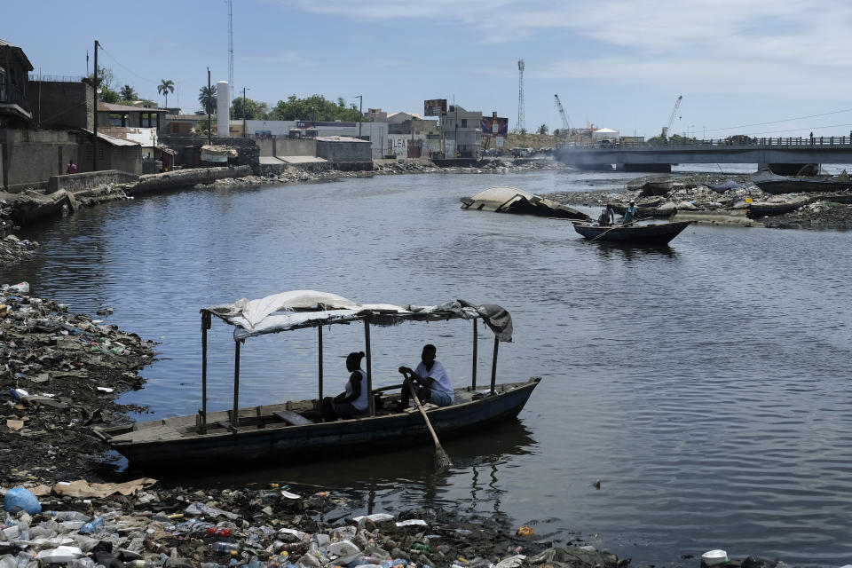 A man waits to row his boat across the river in Cap-Haitien, Haiti, Thursday, July 22, 2021. The city of Cap-Haitien is holding events to honor slain President Jovenel Moïse on Thursday ahead of Friday’s funeral. (AP Photo/Matias Delacroix)