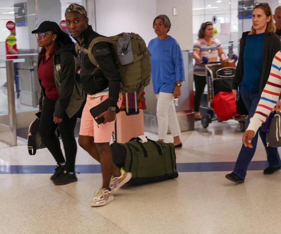 Passengers walk through the Arrivals area after arriving on the first evacuation flight out of Cap-Haitien, Haiti, and arriving at Miami International Airport after the suspension of flights nearly two ago after some Haitian-Americans evacuated and returned to the United States on Sunday, March 17, 2024.