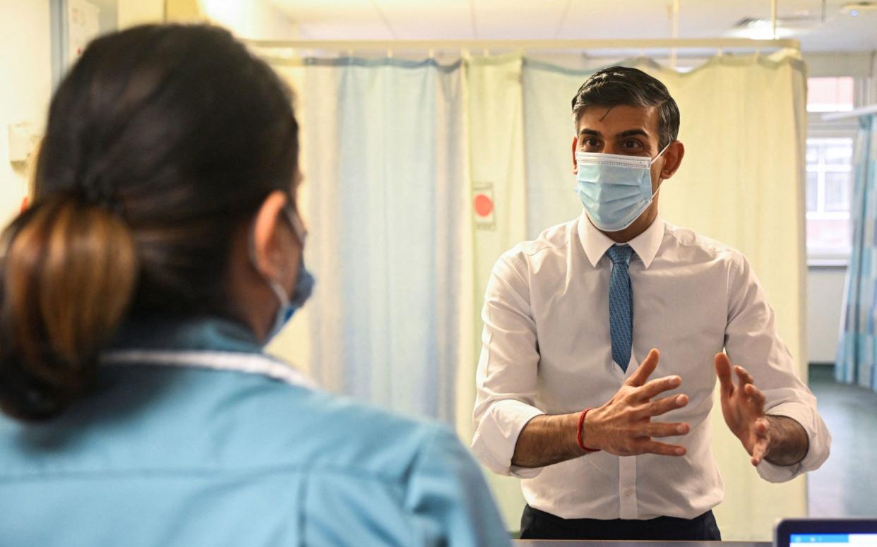 Prime Minister Rishi Sunak speaks with a nurse