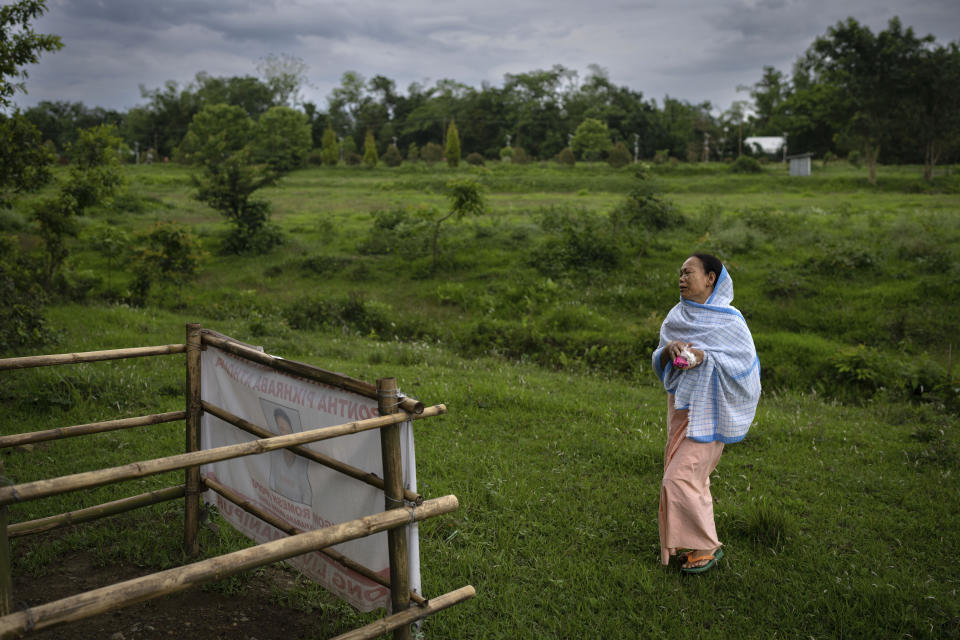 Lilapati Devi, 55, from the Meitei community, mourns by the grave of her husband A. Ramesh Singh who was killed by a mob of tribal Kukis in Phayeng, near Imphal, in the northeastern Indian state of Manipur, Thursday, June 22, 2023. A former soldier, Singh carried a licensed gun with him which he fired in the air and some at the mobs, but was hit in his leg. He was abducted with four others and dragged up the hills and his body found in a grove next day, his son said. He was shot in the head. (AP Photo/Altaf Qadri)