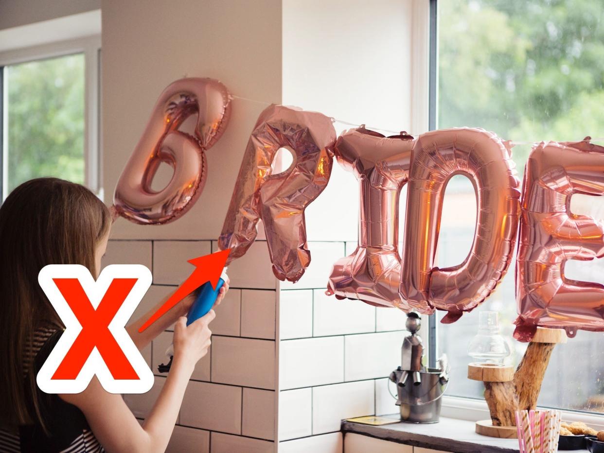 A photo of a woman blowing up a "bride" balloon sign with an X and arrow pointing at it.