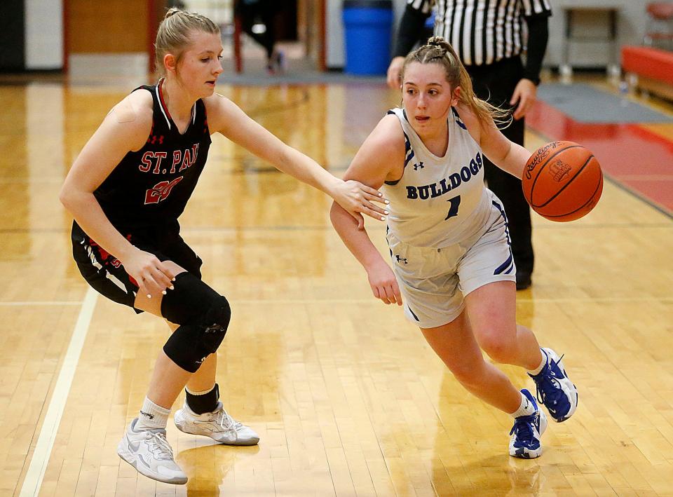 Crestline High School's Kennedi Sipes (1) drives against St. Paul High School's Molly Ridge (20) during their Division IV Northwest District sectional high school girls basketball game at Crestview High School Thursday, Feb. 16, 2023. TOM E. PUSKAR/NEWS JOURNAL