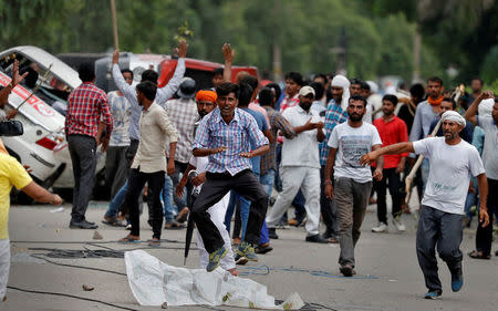 Protestors react during violence in Panchkula, India, August 25, 2017. REUTERS/Cathal McNaughton