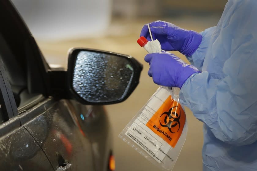 WASHINGTON: A nurse at a drive up COVID-19 coronavirus testing station, set up by the University of Washington Medical Center, holds a swab used to take a sample from the nose of a person in their car.