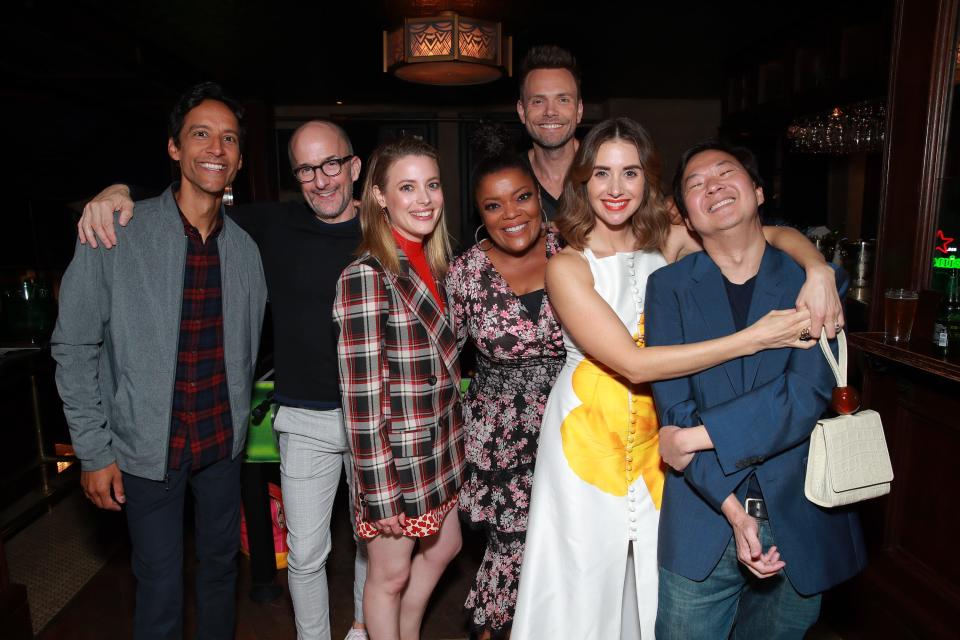 The cast of "Community" - Danny Pudi, left, Jim Rash, Gillian Jacobs, Yvette Nicole Brown, Joel McHale, Alison Brie and Ken Jeong, seen in November 2019 - will return for a YouTube table read and a Q&A on May 18 to raise money for COVID-19 food relief efforts.