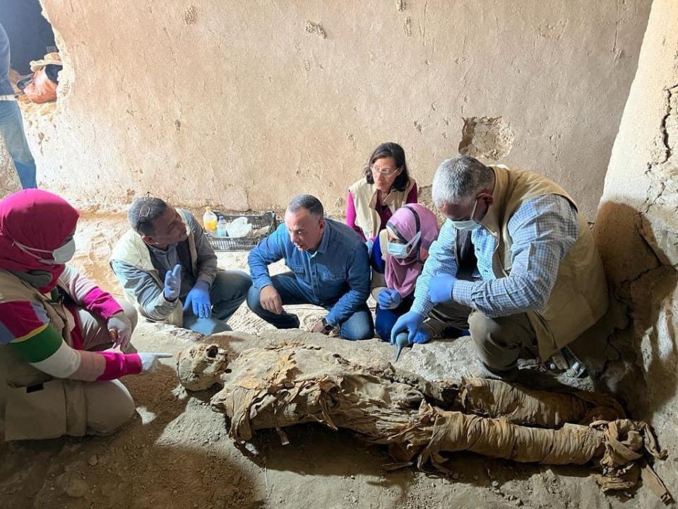 Egyptian archaeologists inspect mummified remains found in a newly discovered burial site in Luxor's Dra' Abu el-Naga' Necropolis, which they said was the first ever found in the area dating back to ancient Egypt's 13th Dynasty, between 1803 BC and 1649 BC. / Credit: Egyptian Ministry of Tourism and Antiquities