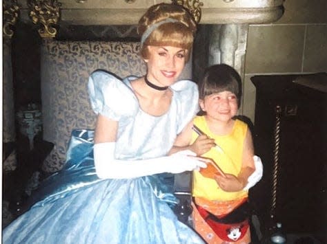 megan posing for a picture with cinderella at disney world as a kid 30 years ago