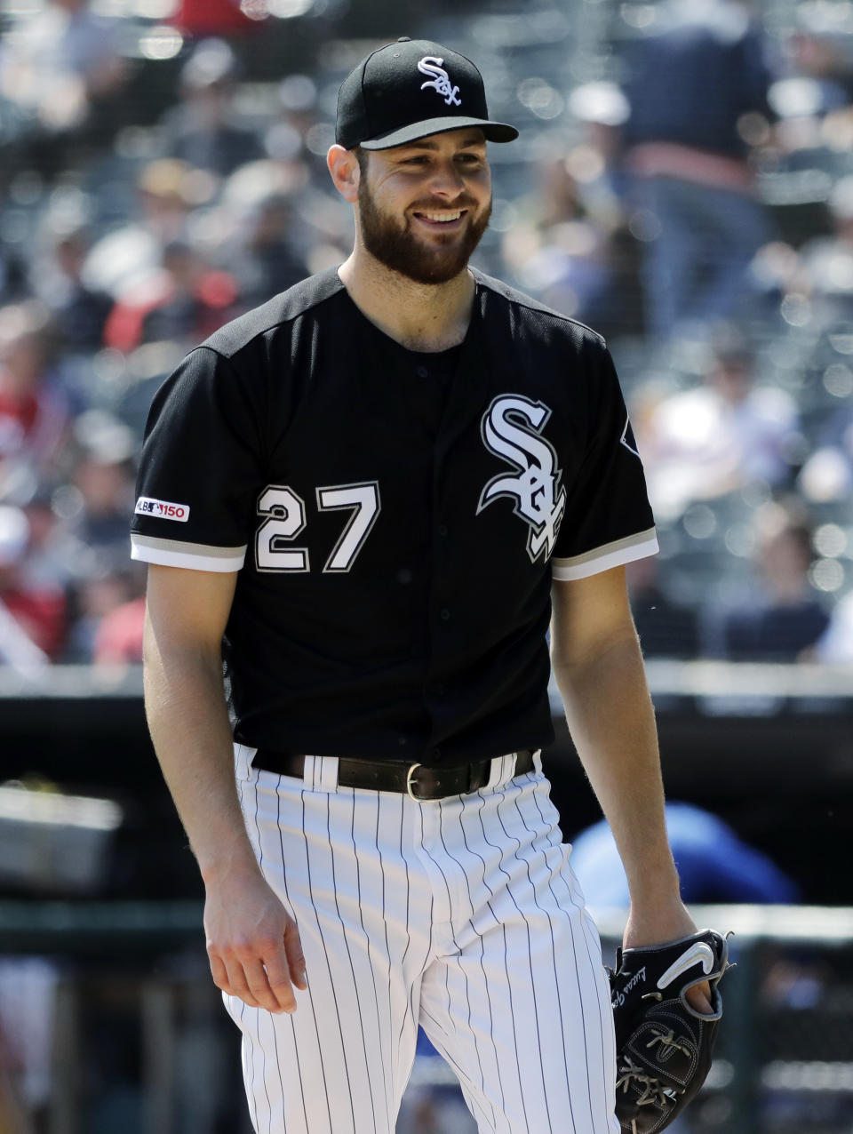 Chicago White Sox starting pitcher Lucas Giolito smiles as he walks back to the dugout during the first inning of a baseball game against the Kansas City Royals, in Chicago, Wednesday, April 17, 2019. (AP Photo/Nam Y. Huh)