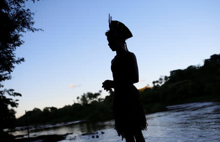 An Indigenous man from the Pataxo Ha-ha-hae tribe is seen next to Paraopeba river, after a tailings dam owned by Brazilian mining company Vale SA collapsed, in Sao Joaquim de Bicas near Brumadinho, Brazil January 28, 2019. REUTERS/Adriano Machado