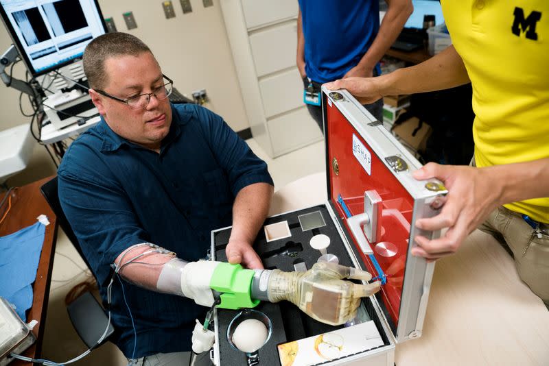 Joe Hamilton, a participant in the University of Michigan RPNI study, uses his mind to control a DEKA prosthetic hand