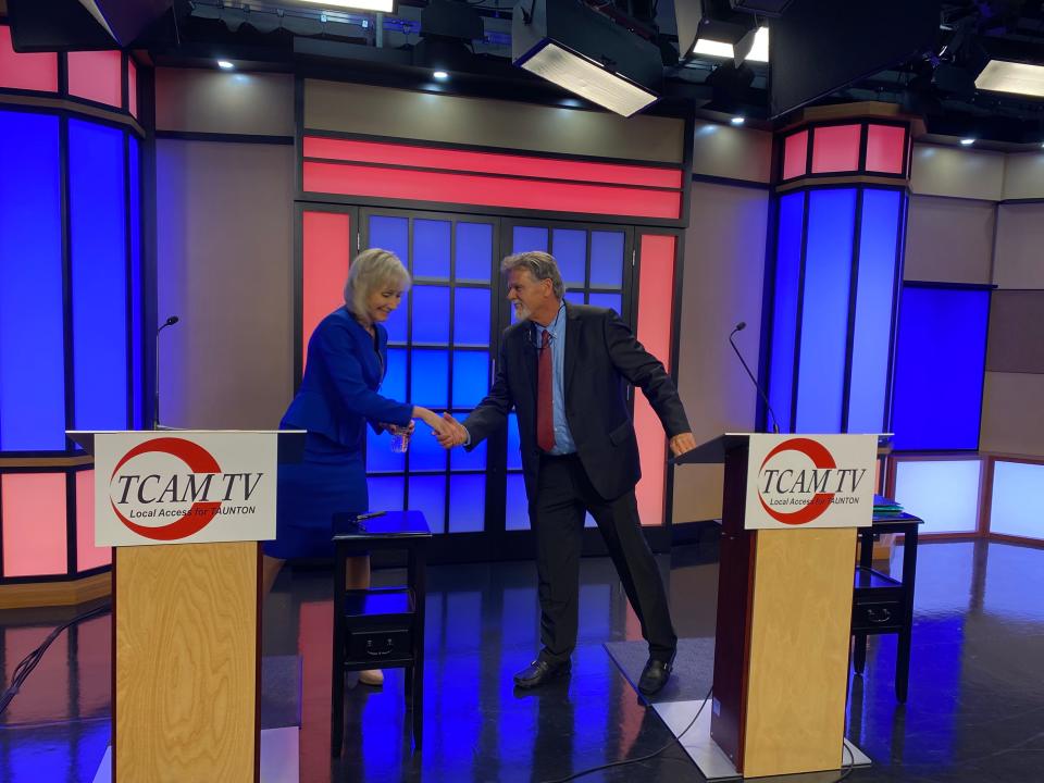 Taunton Mayor Shaunna O'Connell and opponent Ed Correira shake hands before squaring off inside TCAM's studio for a candidates night debate forum on Thursday, Oct. 26, 2023.
