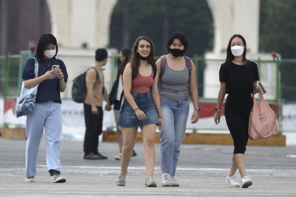 People wear face masks to protect against the spread of the coronavirus in Taipei, Taiwan, Wednesday, April 27, 2022. (AP Photo/Chiang Ying-ying)