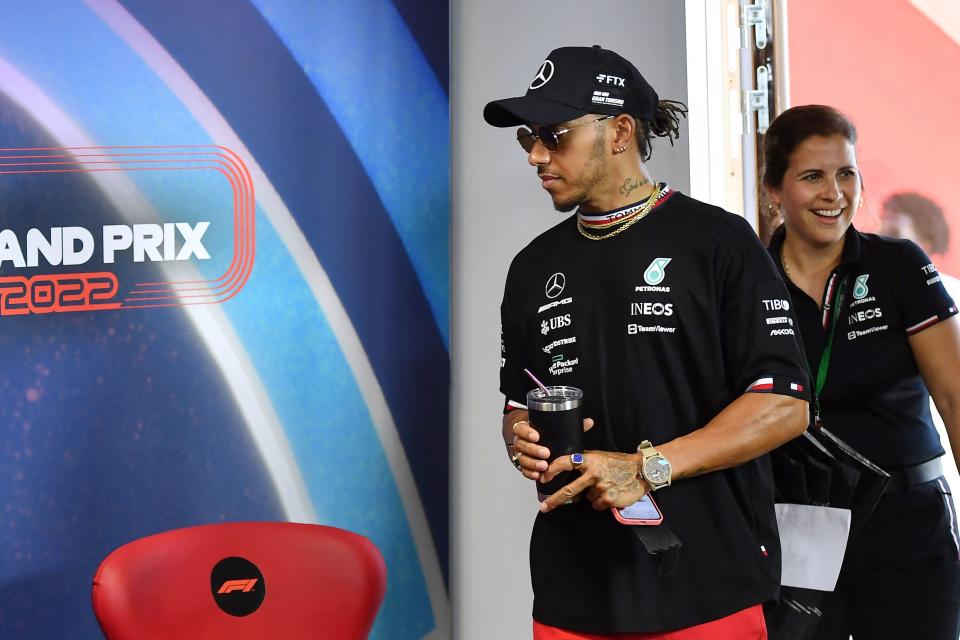 Mercedes' British driver Lewis Hamilton (L) arrives for a press conference on the eve of the start of the F1 French Grand Prix 2022, on the Circuit Paul Ricard in Le Castellet, southern France, on July 21, 2022. - The French Formula 1 Grand Prix will play an important card for its future from July 22 to July 24 on the Castellet circuit, with an unprecedented mobility plan for the 200,000 spectators expected. (Photo by Sylvain THOMAS / AFP) (Photo by SYLVAIN THOMAS/AFP via Getty Images)