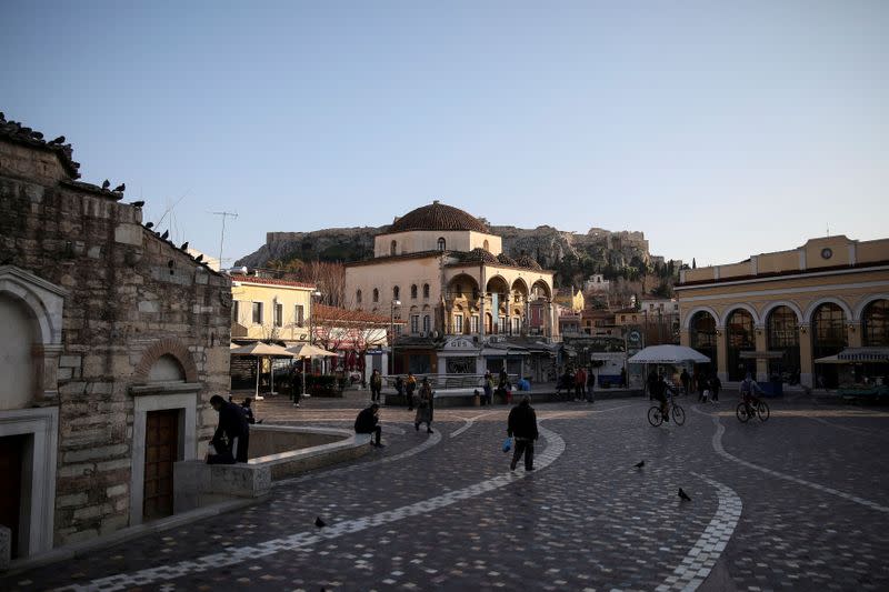 FILE PHOTO: People make their way on Monastiraki Square, amid the coronavirus disease (COVID-19) pandemic, in Athens