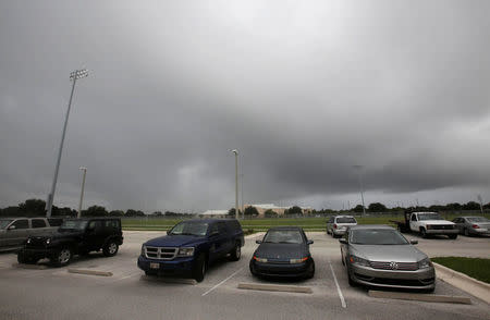 Parked cars are seen outside at a school being used as a shelter while Hurricane Matthew approaches in Melbourne, Florida, U.S. October 6, 2016. REUTERS/Henry Romero