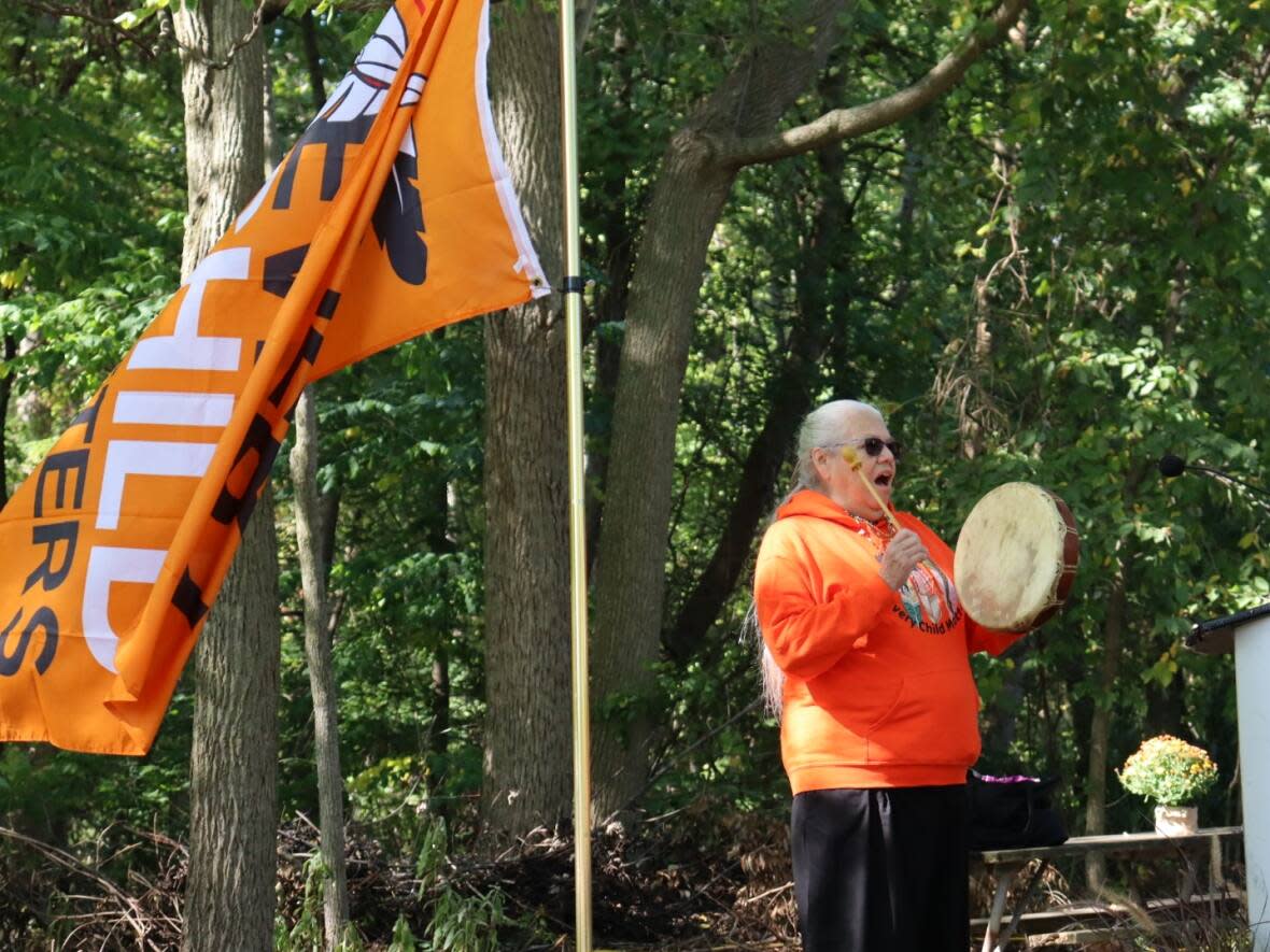 Theresa Sims spoke and sang traditional songs at the event in Ojibway Park Friday. Sims is Windsor's Indigenous Storyteller and is the cultural language specialist at Ska:na Family Learning Centre.  (Jennifer La Grassa/CBC - image credit)