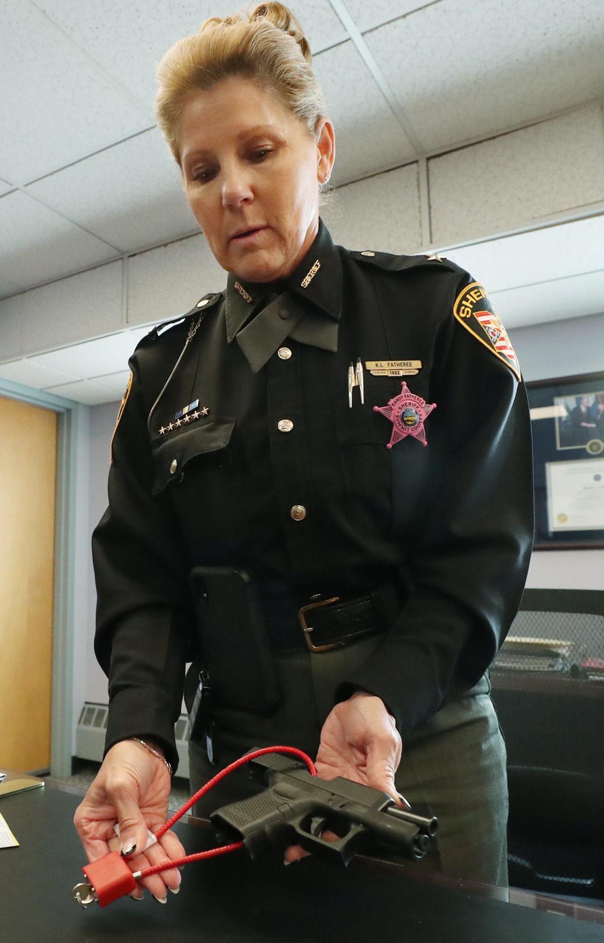 Summit County Sheriff Kandy Fatheree talks about the importance of gun locks and demonstrates how to use one.