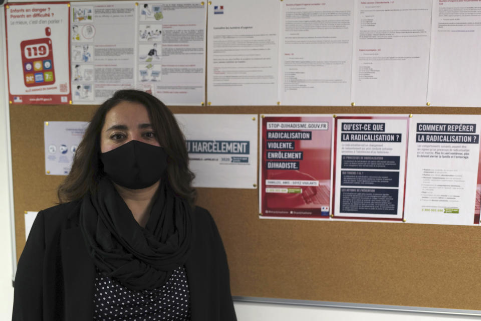 Hanane Loukili, head of the MHS, Meo High School private college, poses at the school in Paris, Tuesday, Feb. 9, 2021. More than three dozen police officers descended on the small private school, blocked students inside their classrooms, took photos everywhere, even inside the refrigerator, and grilled the school director in her office. Loukili later learned the Nov. 17 raid was carried out by a team from a special cell sweeping schools, shops, clubs or mosques to rout out radicalization. Loukili insists she is no radical. (AP Photo/Francois Mori)