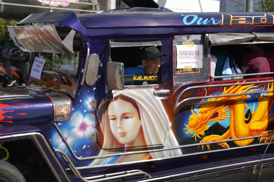 A driver looks out from his passenger jeepney as he joins a rally during a transport strike in Quezon city, Philippines on Monday, March 6, 2023. Philippine transport groups launched a nationwide strike Monday to protest a government program drivers fear would phase out traditional jeepneys, which have become a cultural icon, and other aging public transport vehicles. (AP Photo/Aaron Favila)