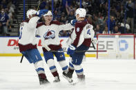 Colorado Avalanche defenseman Cale Makar (8) celebrates his shootout goal against the Tampa Bay Lightning with defenseman Jack Johnson (3) and defenseman Bowen Byram (4) during an NHL hockey game Saturday, Oct. 23, 2021, in Tampa, Fla. (AP Photo/Chris O'Meara)