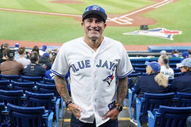 Male vendor in Red Blue Jays Jersey on Canada Day weekend selling