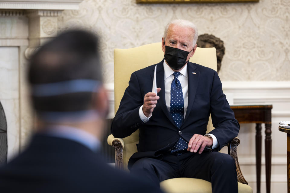 U.S. President Joe Biden wears a protective mask while speaking during a meeting with the Congressional Hispanic Caucus in the Oval Office of the White House in Washington, D.C., U.S., on April 20, 2021. (Doug Mills/The New York Times/Bloomberg via Getty Images)