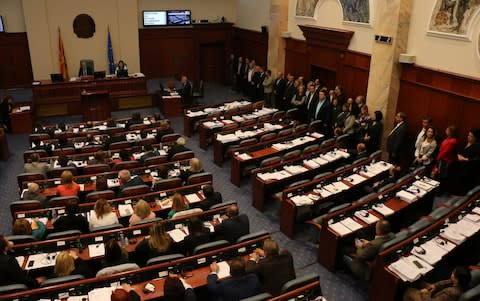 Opposition members of parliament stand to boycott the vote as Macedonia's MPs vote to start changing constitutional amendments - Credit: Getty Images