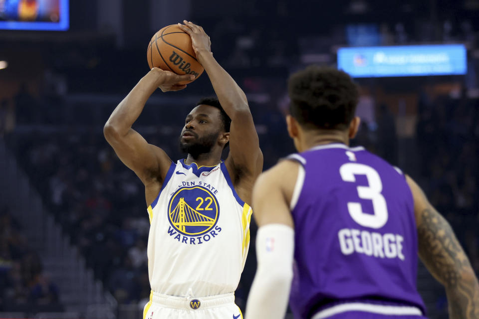Golden State Warriors forward Andrew Wiggins (22) looks to shoot against Utah Jazz guard Keyonte George (3) during the first half of an NBA basketball game in San Francisco, Sunday, April 14, 2024. (AP Photo/Jed Jacobsohn)