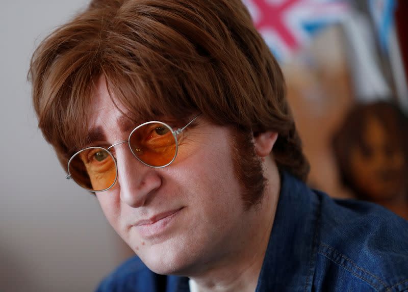 Javier Parisi, who impersonates late former Beatle John Lennon, looks on during an interview with Reuters, in Lanus, on the outskirts of Buenos Aires