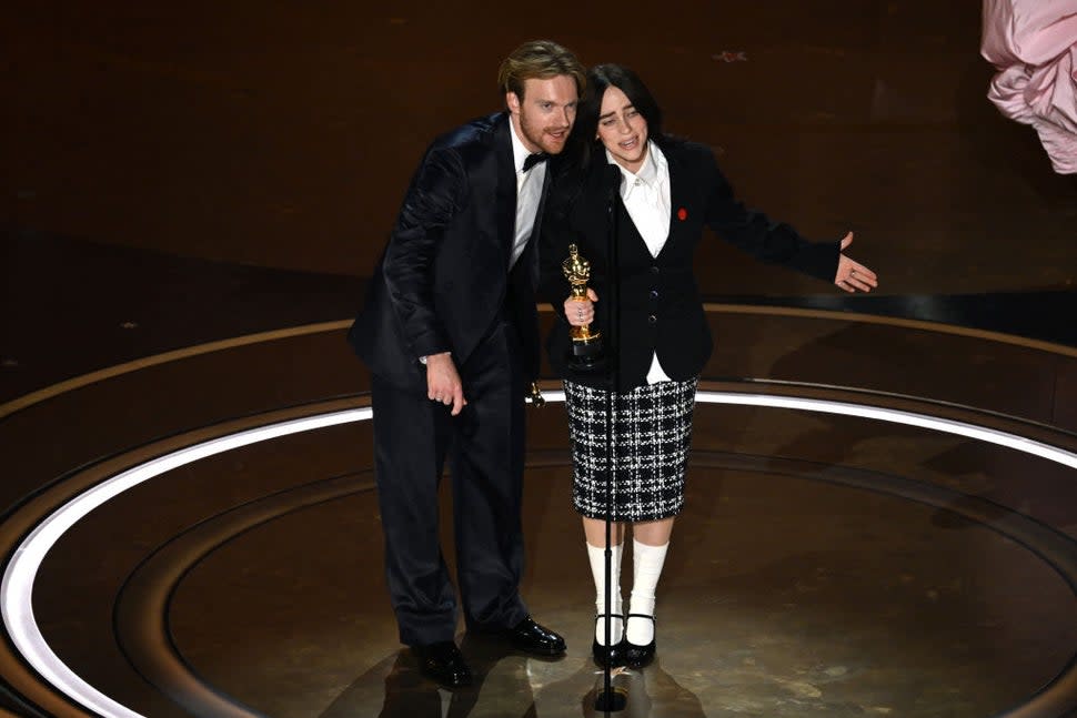 Billie Eilish and Finneas O'Connell accepting their Oscar 