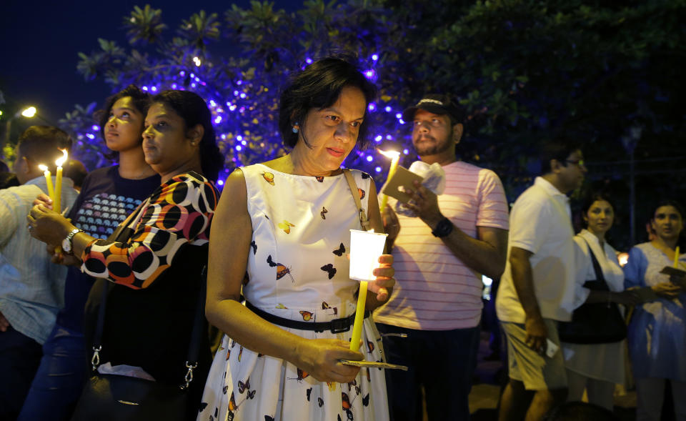 Pro- democratic Sri Lankans take part in a candle light vigil in Colombo, Sri Lanka, Sunday, Nov. 11, 2018. The crowd demanded the restoration of democracy after President Maithripala Sirisena dissolved Parliament and called for fresh elections. (AP Photo/Eranga Jayawardena)