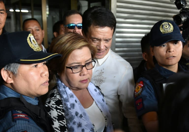 Philippine Senator Leila De Lima (C), a top critic of President Rodrigo Duterte, is escorted by police officers and her lawyer Alex Padilla (R) after her arrest at the Senate in Manila on February 24, 2017