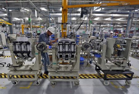 An employee assembles medium voltage switchgears inside the plant of Schneider Electric Infrastructure Ltd. on the outskirts of Vadodara in Gujarat, India, November 5, 2015. REUTERS/Amit Dave