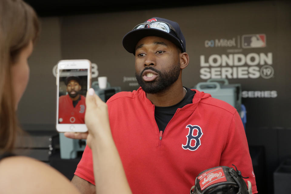 Boston Red Sox's Jackie Bradley Jr. talks after batting practice in London, Friday, June 28, 2019. Major League Baseball will make its European debut with the New York Yankees versus Boston Red Sox game at London Stadium this weekend. (AP Photo/Tim Ireland)