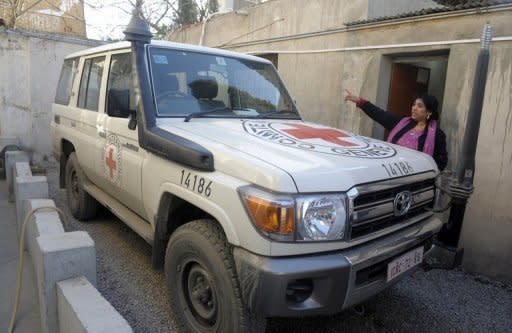 A Pakistani employee of the International Committee of the Red Cross is seen next to the vehicle of kidnapped British employee Khalil Dale in Quetta on January 5. Dale has been found dead in Quetta, nearly four months after his abduction in January, the Red Cross announced